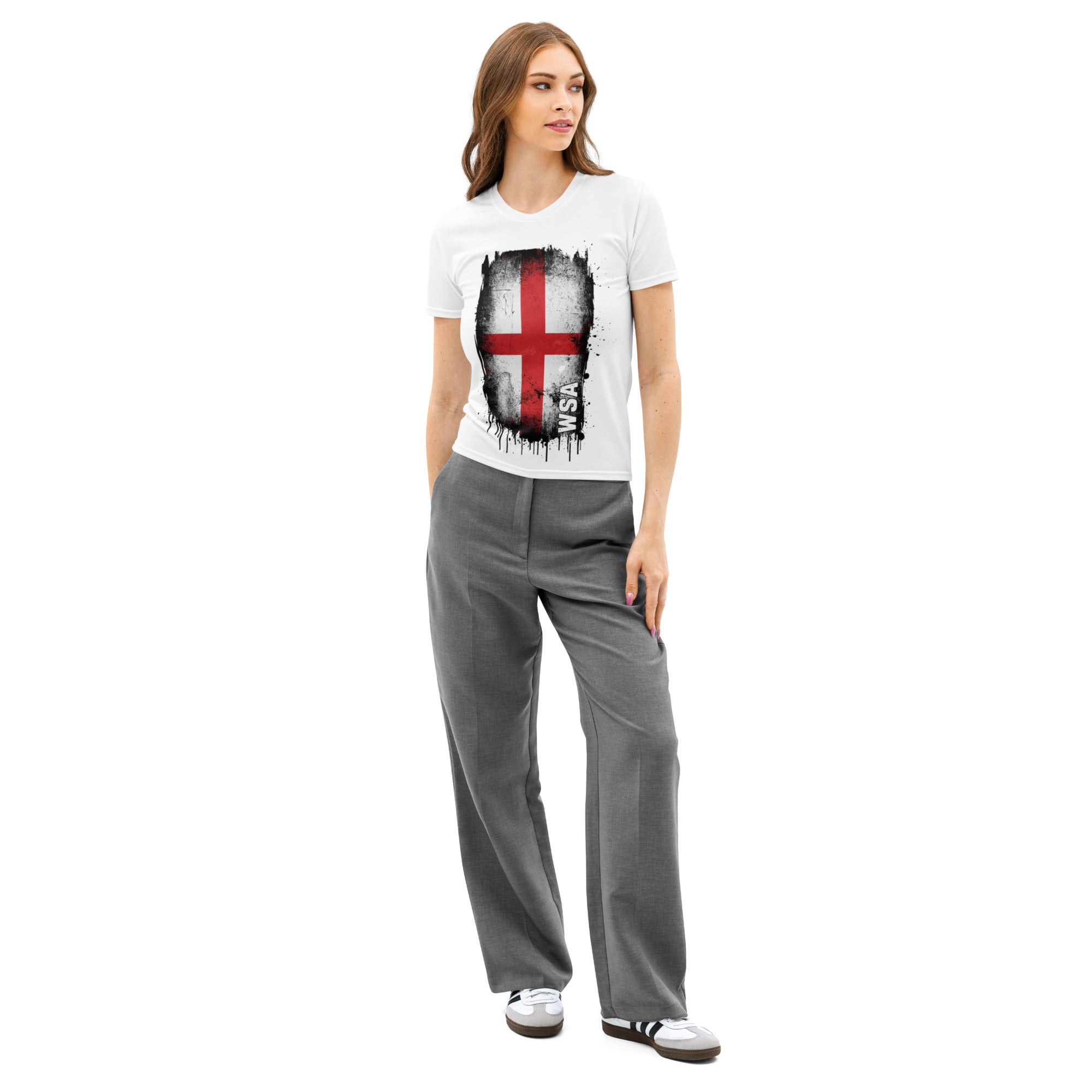 Woman wearing a white t-shirt with a graphic design and gray pants on a white background