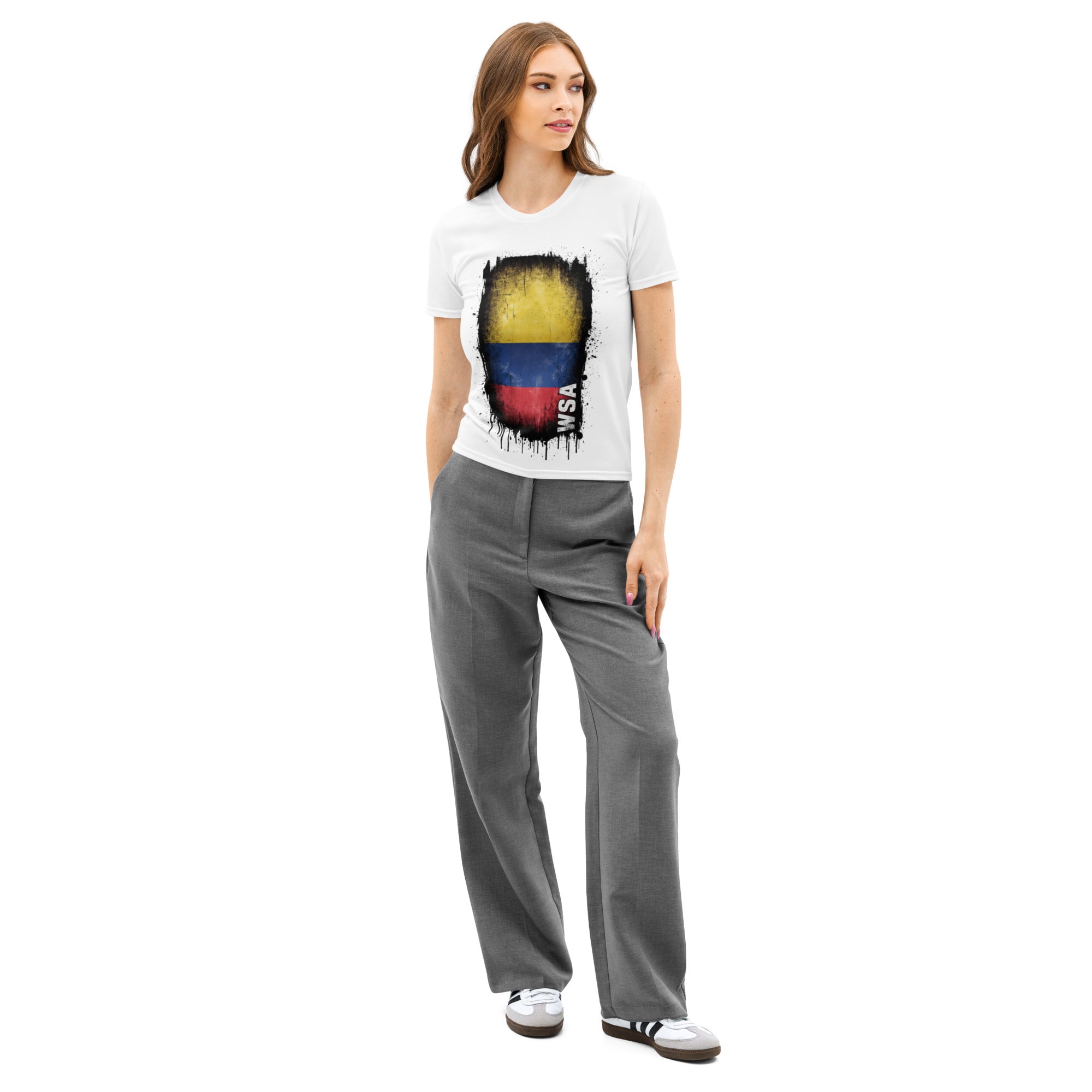 Woman wearing a white t-shirt with a colorful graphic and gray pants on a white background