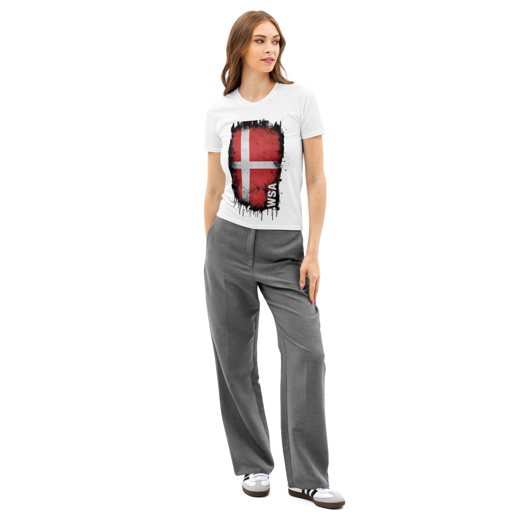 Woman wearing a white t-shirt with a graphic design and gray pants on a white background