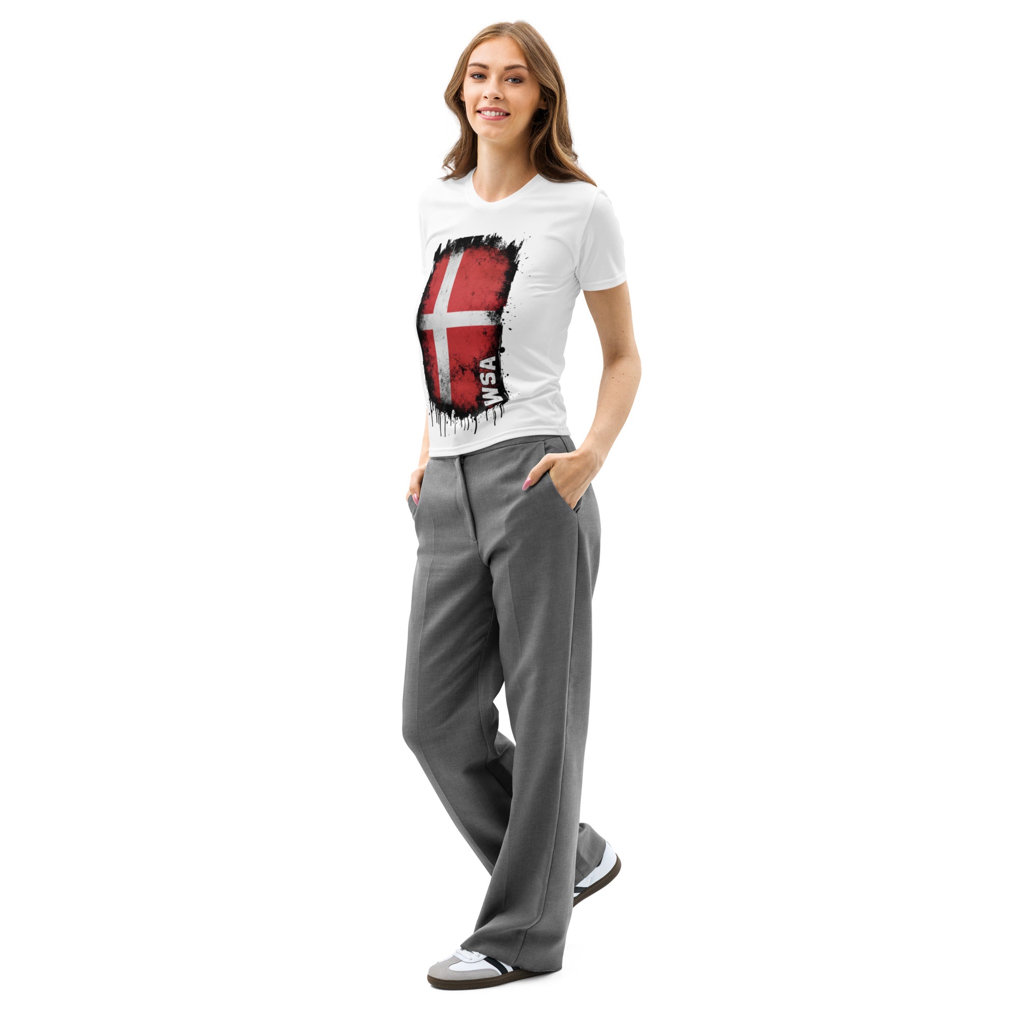 Woman wearing a white t-shirt with a graphic design and gray pants on a white background