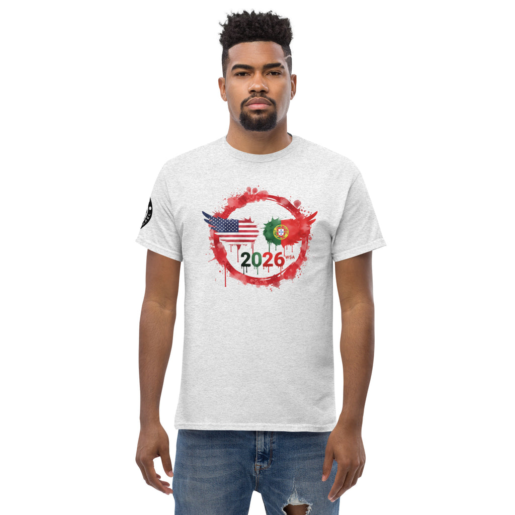 Man wearing a white t-shirt with a graphic design featuring the American and Portuguese flags and the year 2026 on a white background.