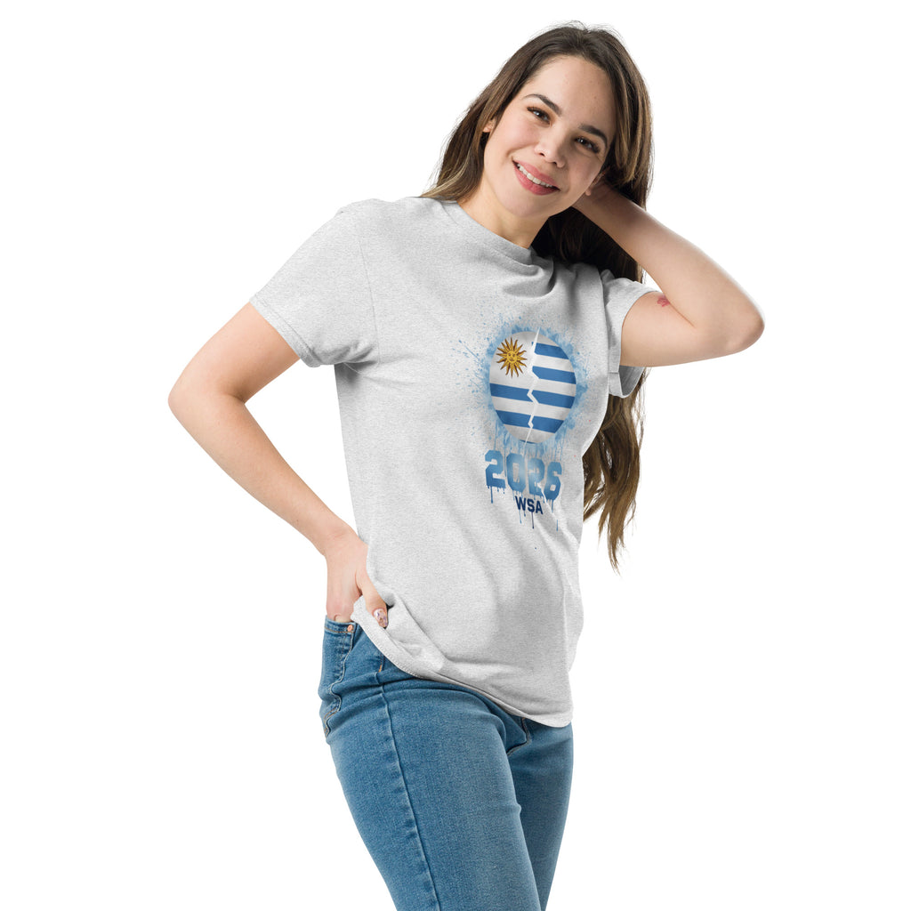 Woman wearing a gray t-shirt with a logo and text, standing against a white background