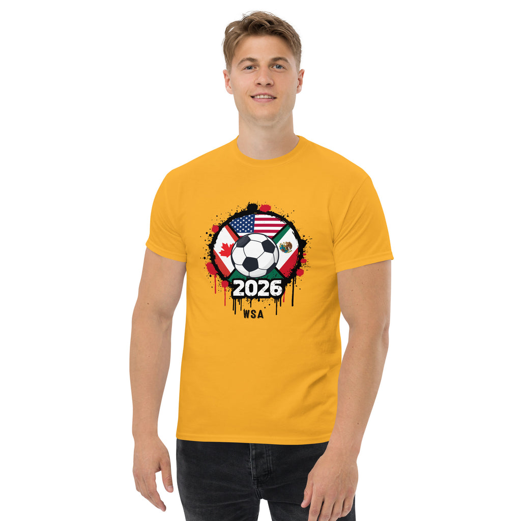 Person wearing a yellow t-shirt with a soccer ball design featuring flags and '2026' text.