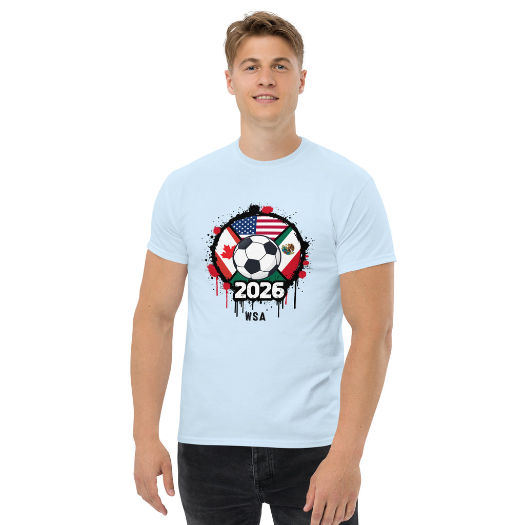 Person wearing a light blue t-shirt with a soccer ball design featuring flags and '2026' text.
