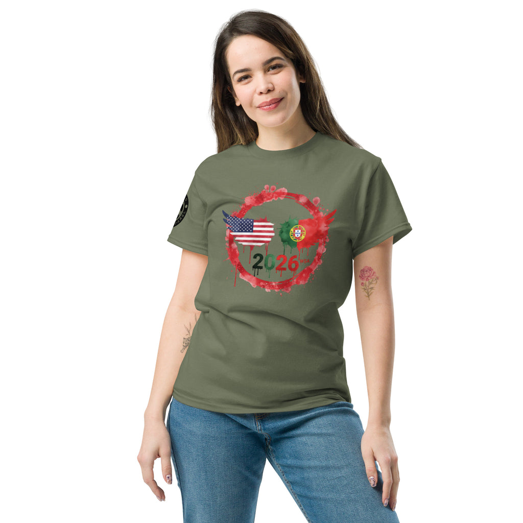 Woman wearing a green t-shirt with a design featuring an American flag and a Portuguese flag, with the number 2026, on a white background.