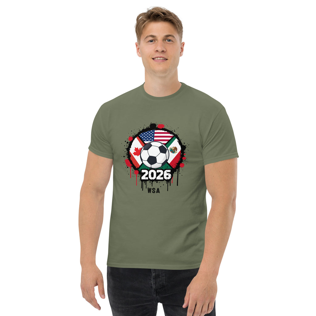 Man wearing a green t-shirt with a soccer ball design featuring flags and '2026' text on a white background.