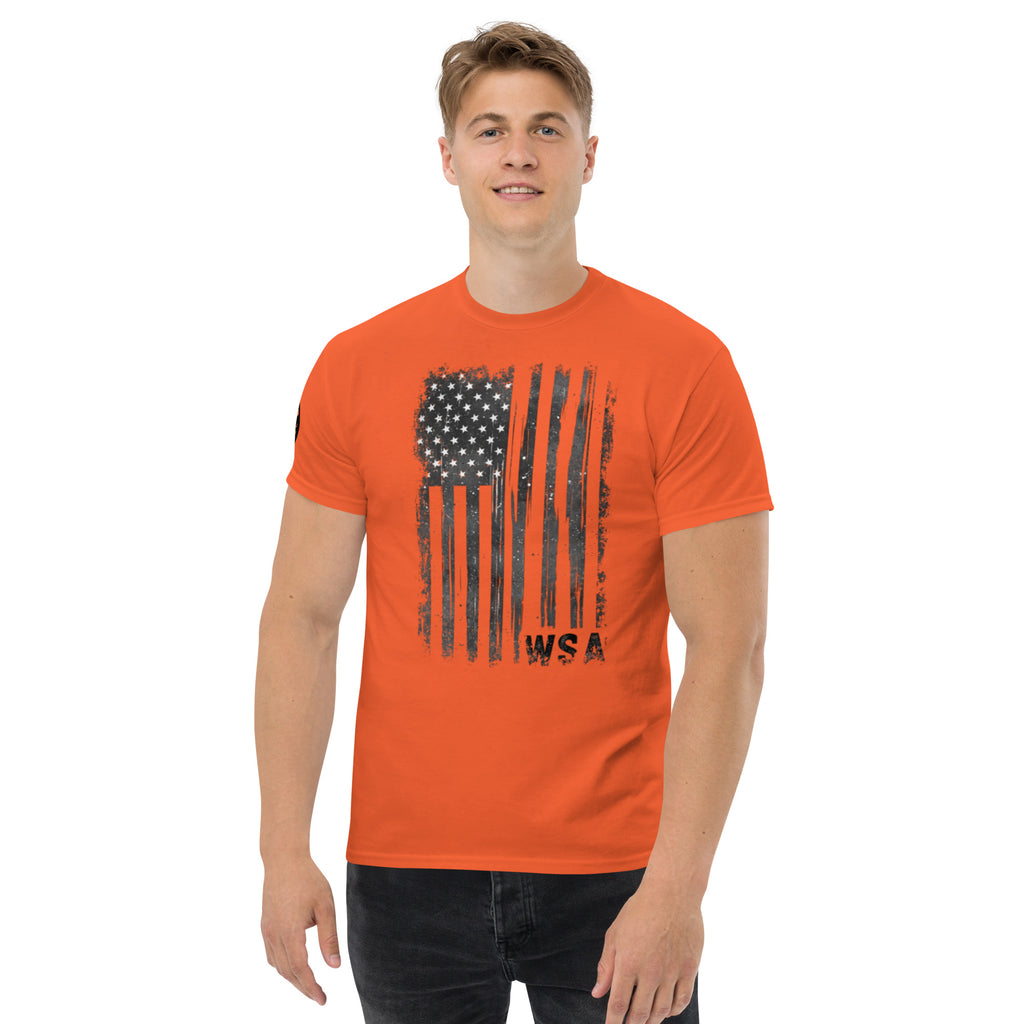 Man wearing an orange t-shirt with a black American flag graphic on a white background