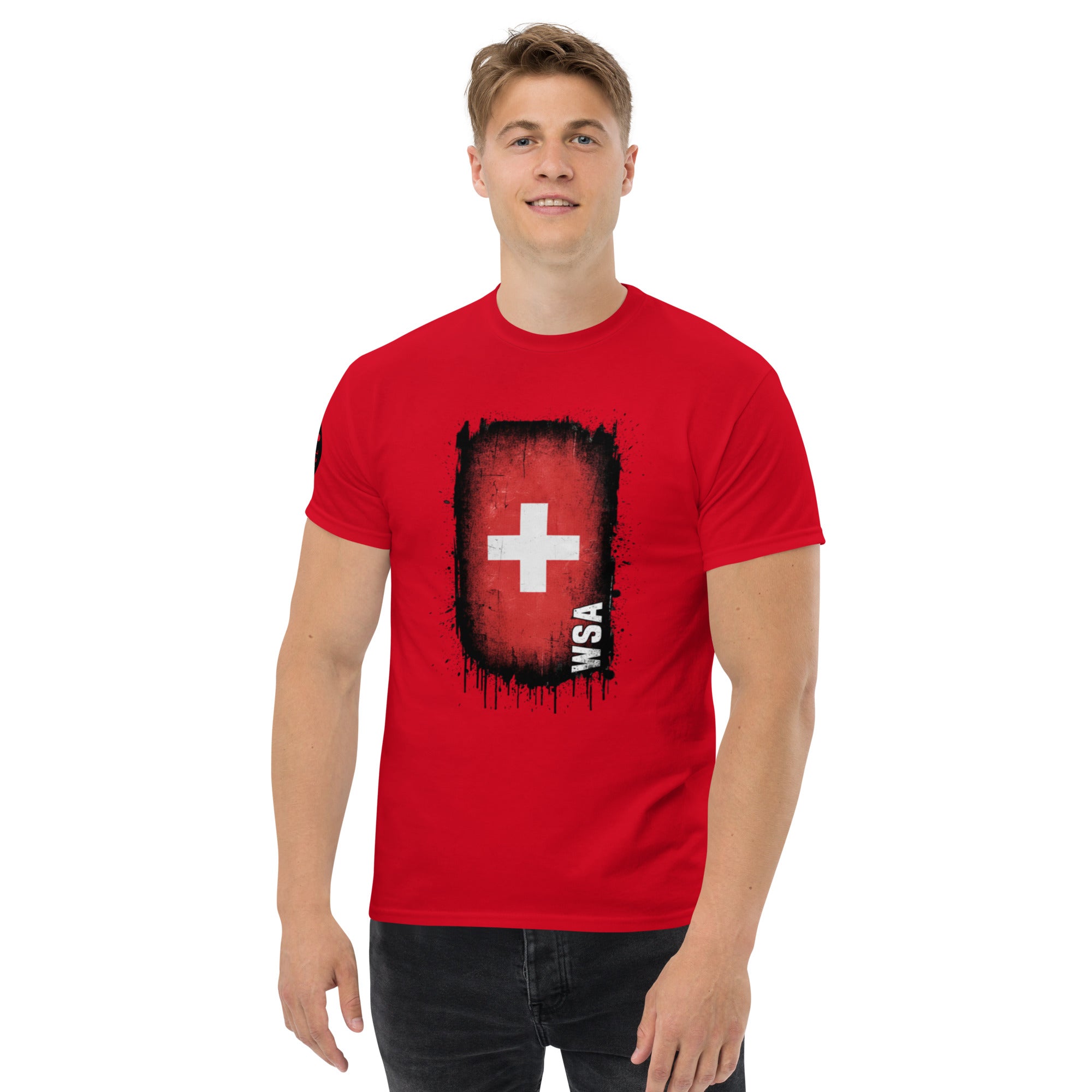Man wearing a red t-shirt with a white cross design on a white background
