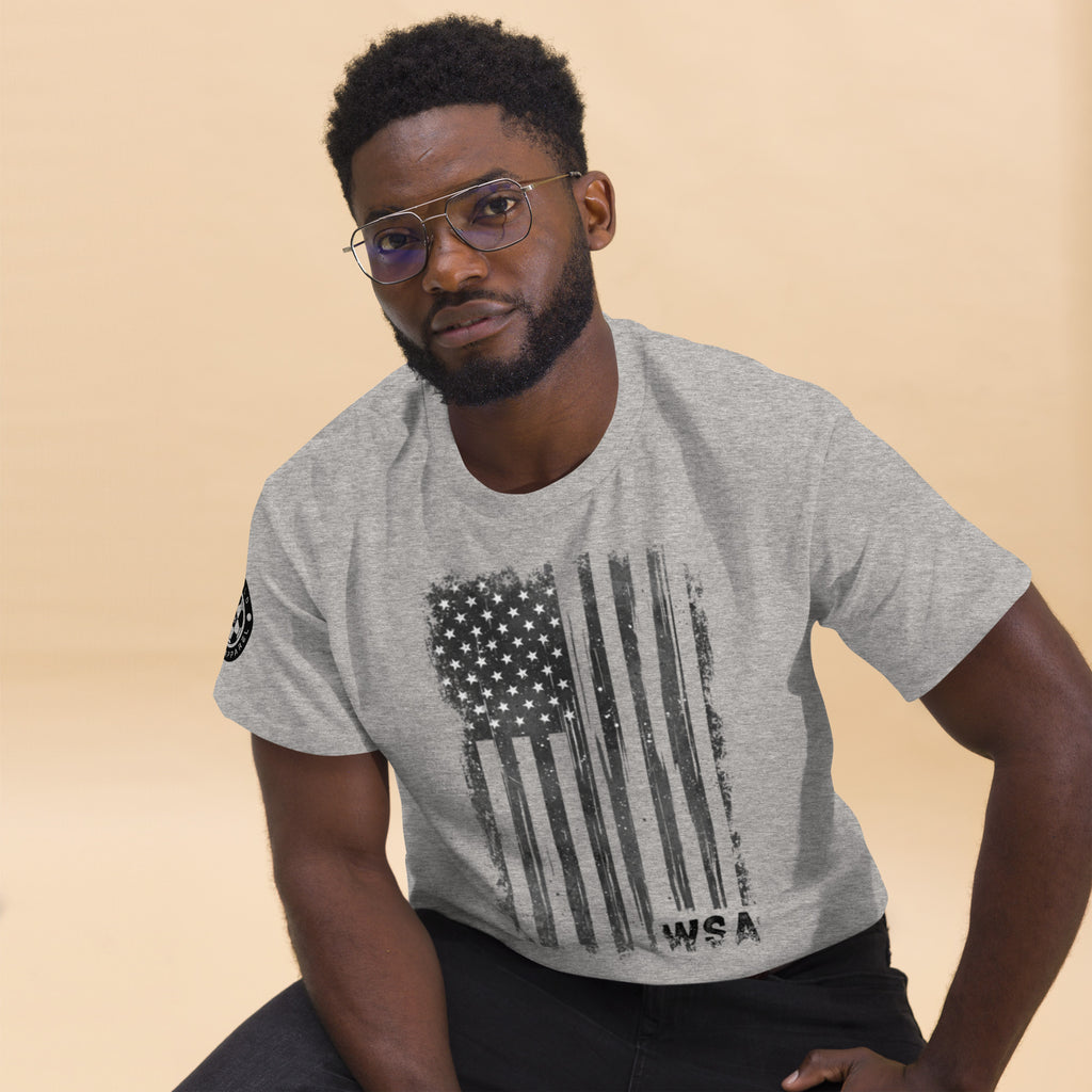 Man wearing a gray t-shirt with an American flag design on a beige background