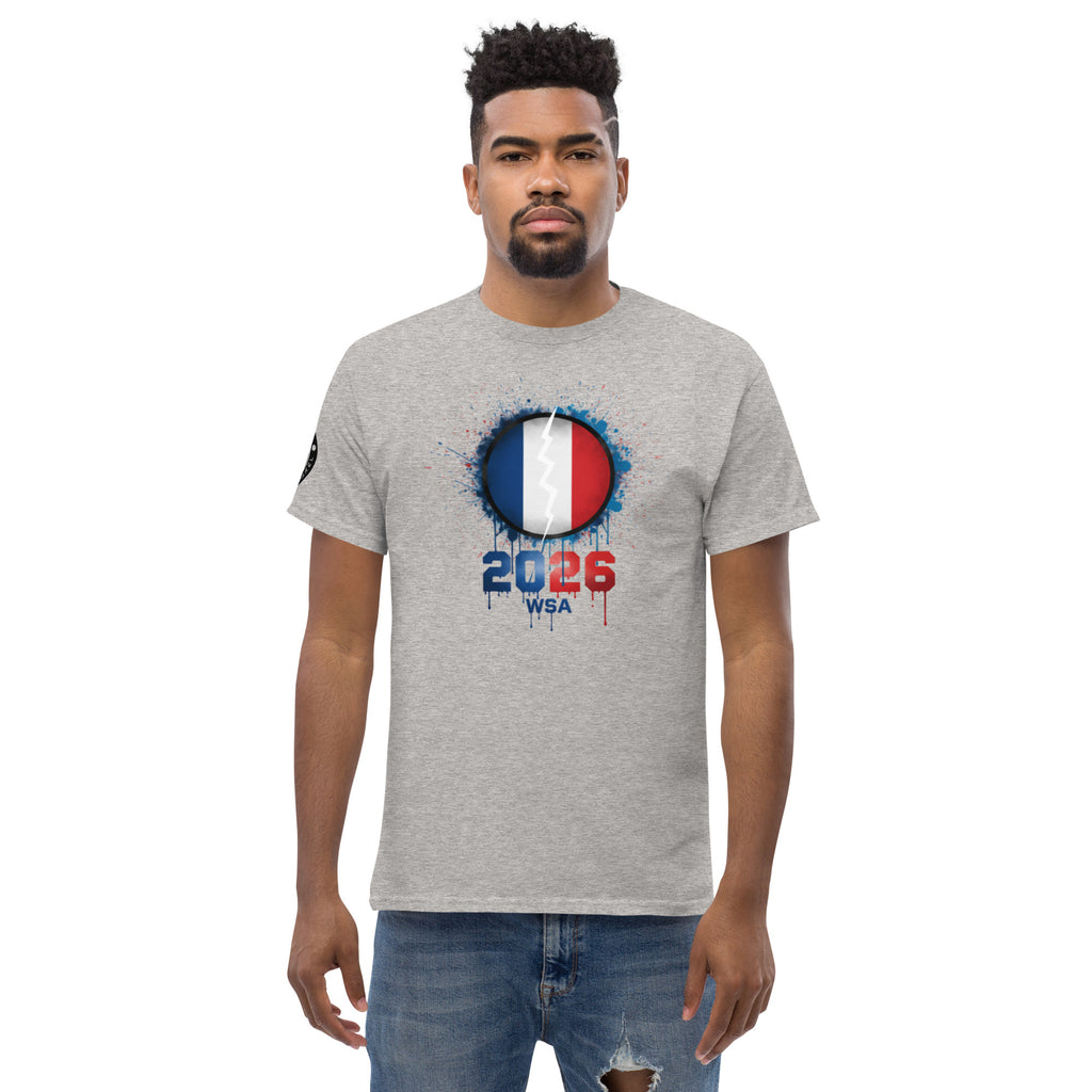 Man wearing a gray t-shirt with a design featuring the number 2026 and text on a white background