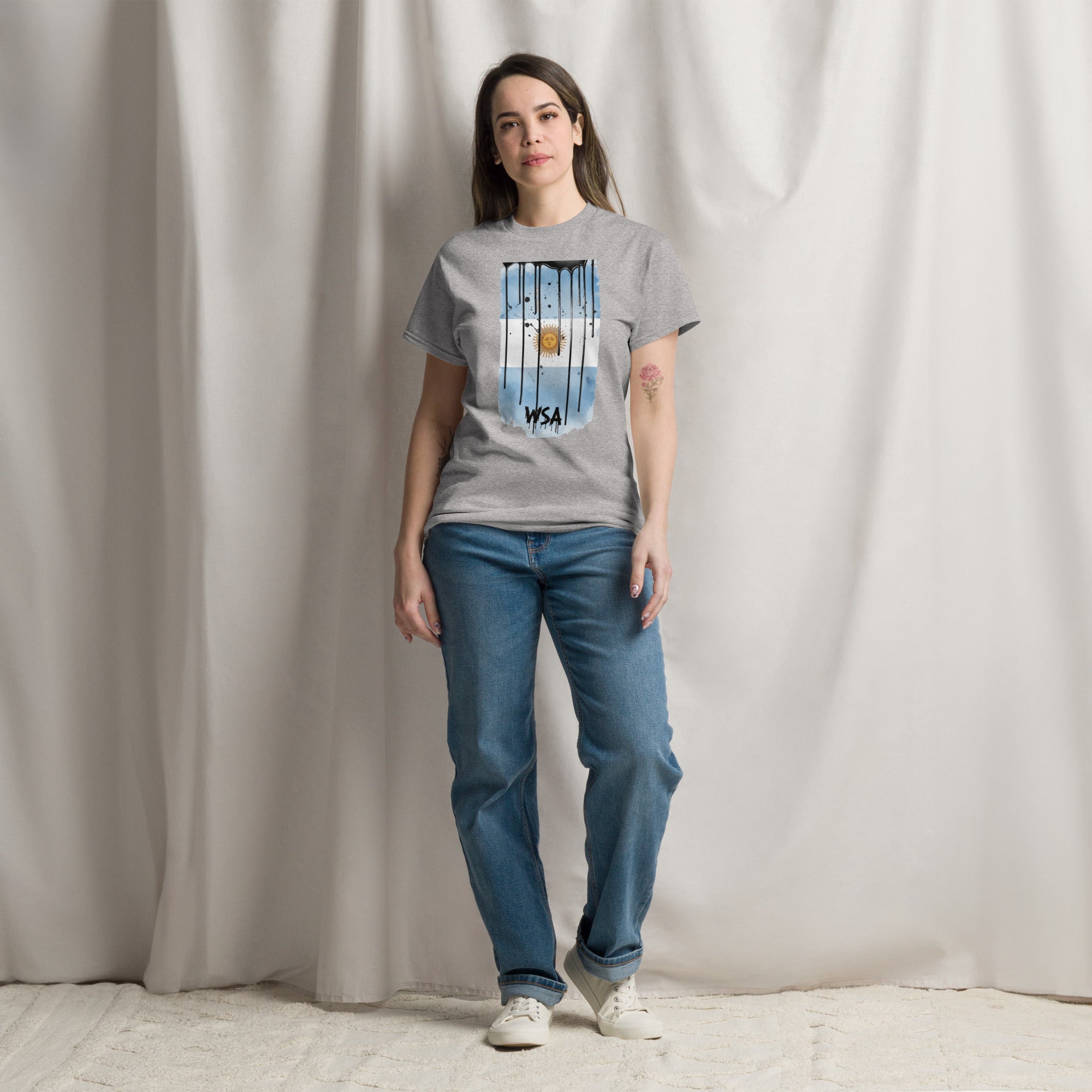 Person wearing a gray t-shirt with 'consistency is key' text against a plain background