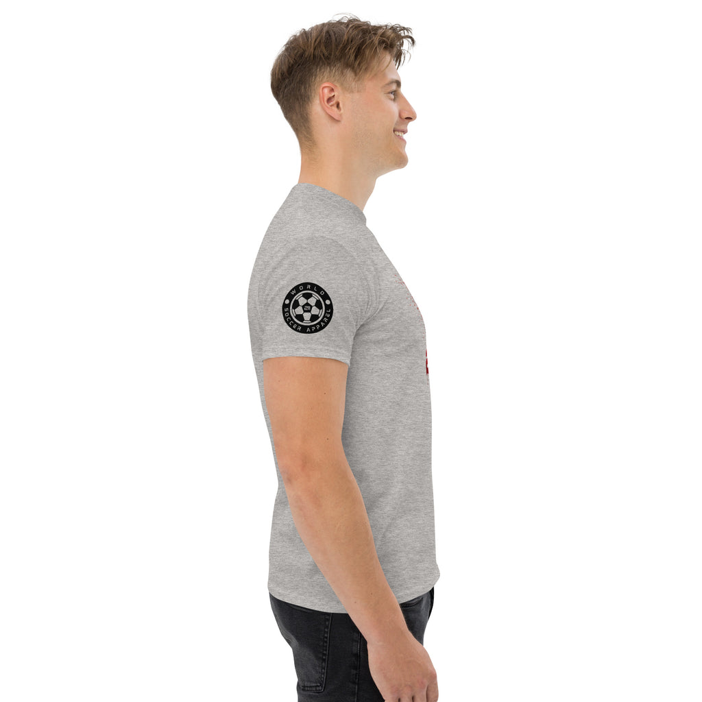 Man wearing a gray t-shirt with a black logo on the sleeve against a white background