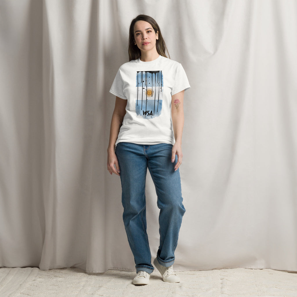 Woman wearing a white t-shirt with colorful text and blue jeans against a plain background
