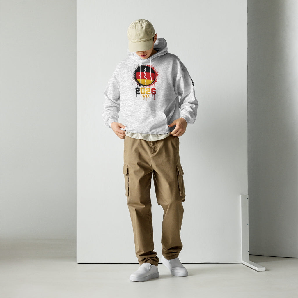 Person wearing a white hoodie with a colorful design and brown cargo pants on a plain background