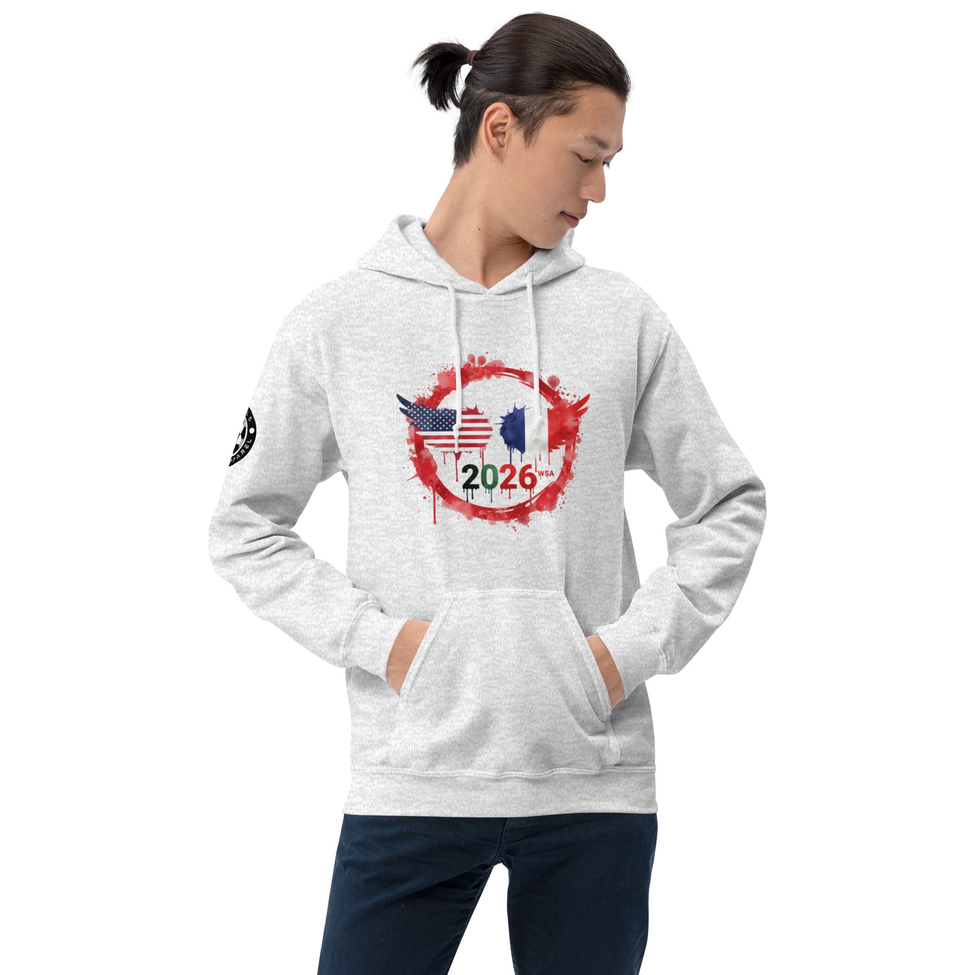 Person wearing a gray hoodie with a design featuring the number 2026 on a white background