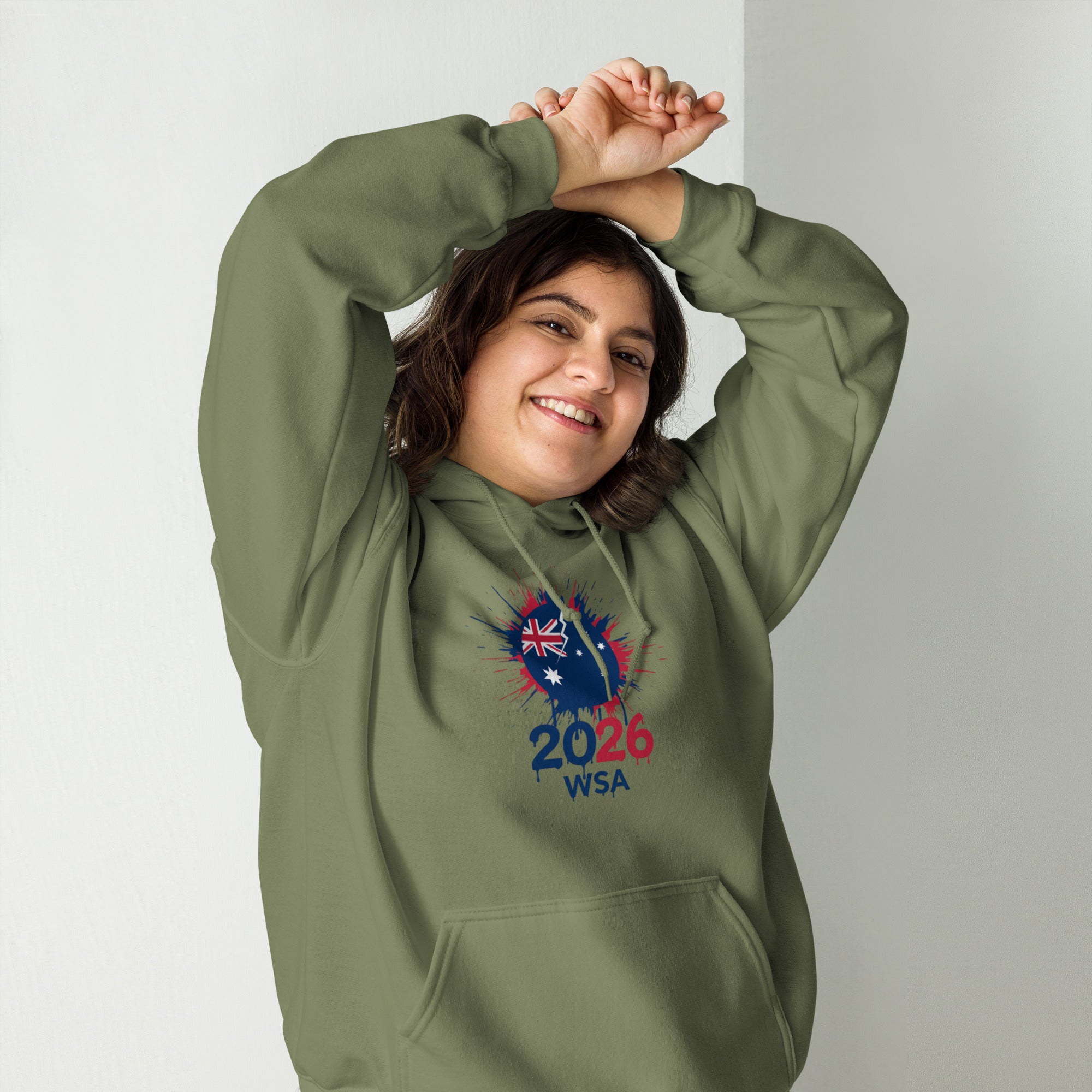 Person wearing a green hoodie with a design and text, standing against a plain background