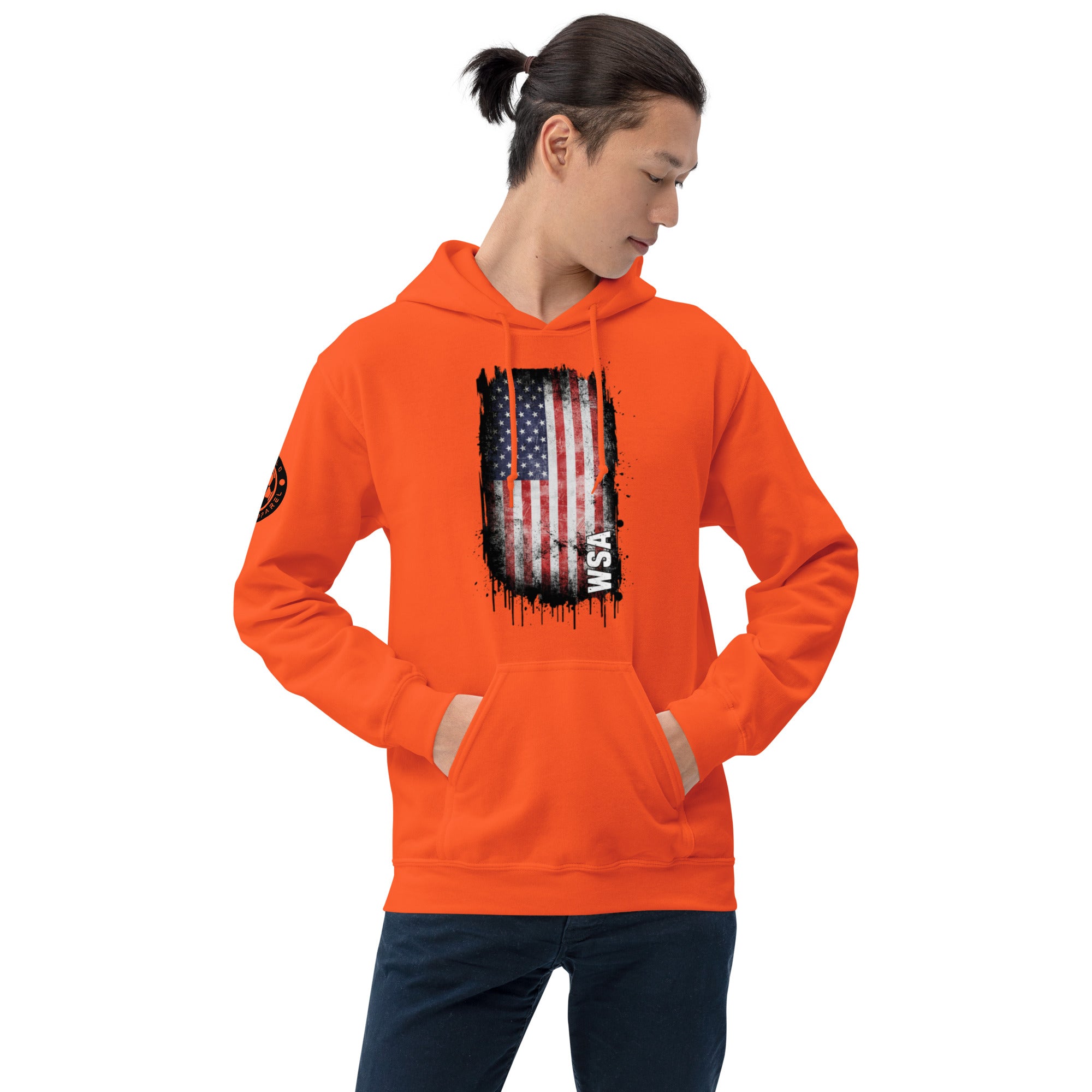 Person wearing an orange hoodie with a graphic design on a white background