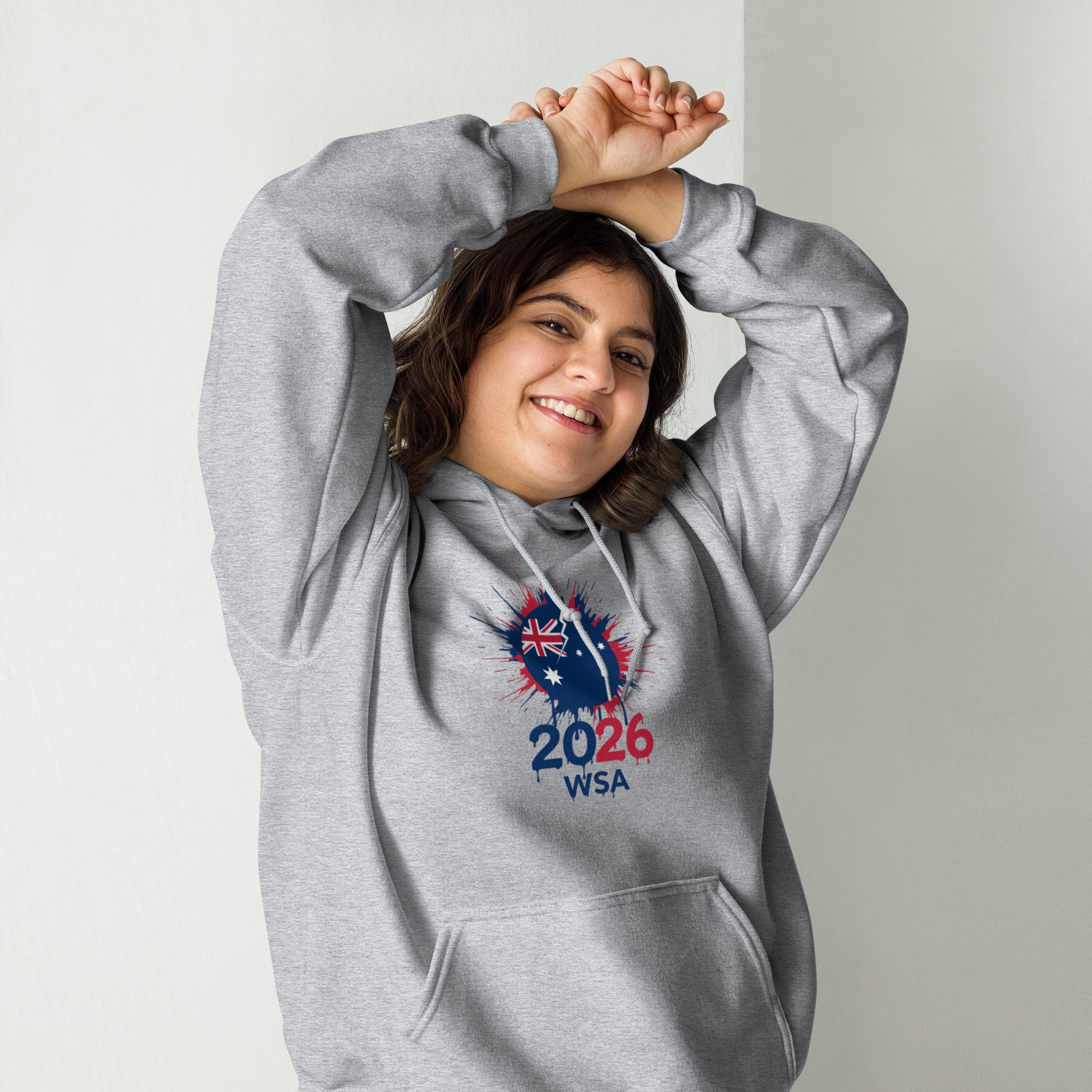 Person wearing a gray hoodie with a design and text on a plain background