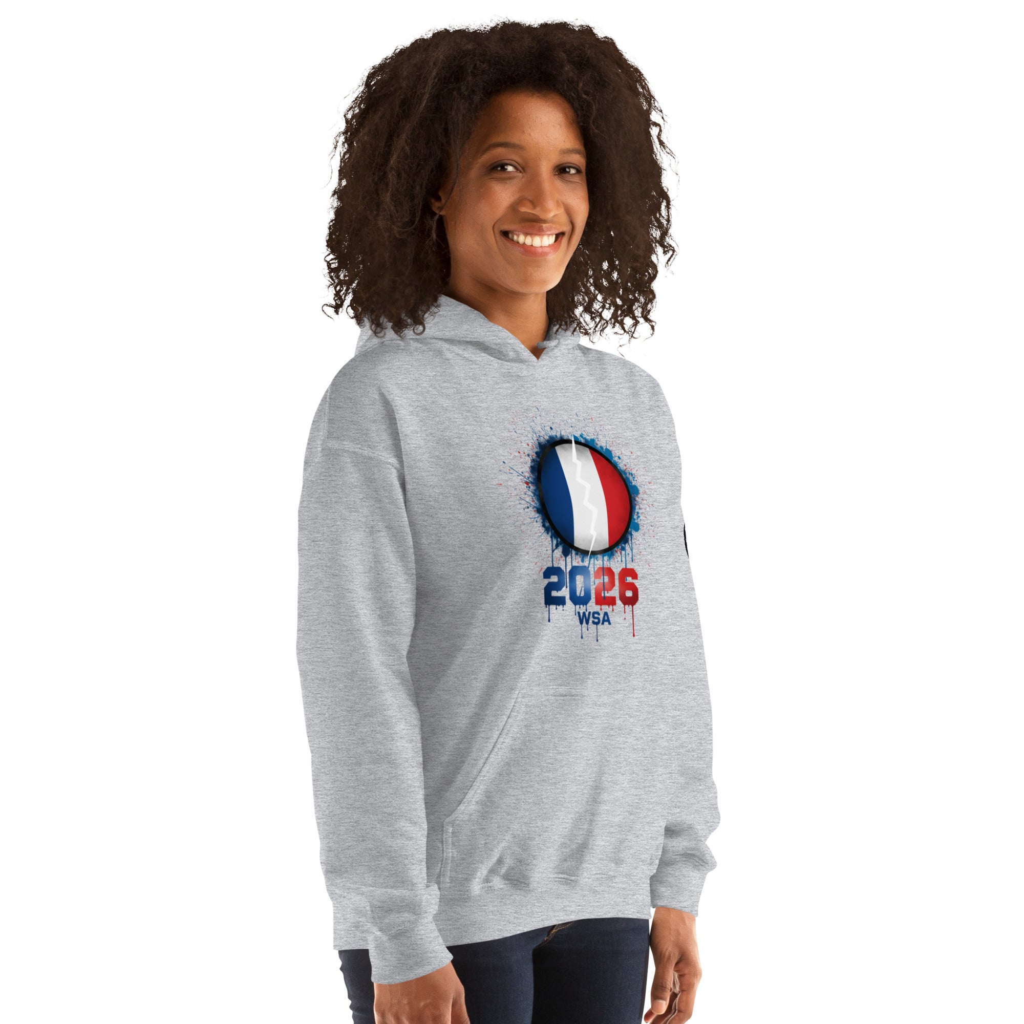 Person wearing a gray hoodie with a design featuring the number 2026 and text on a white background