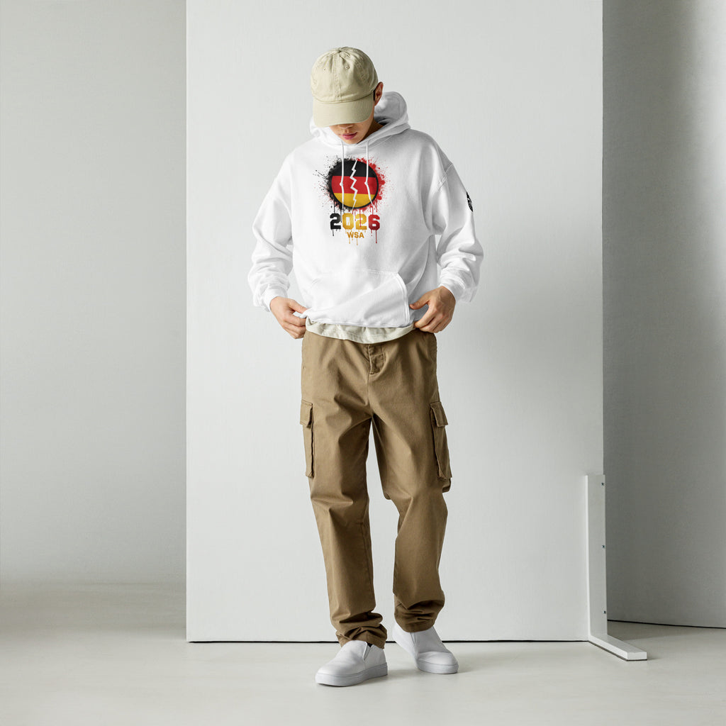 Person wearing a white hoodie with a colorful design and brown cargo pants on a plain background