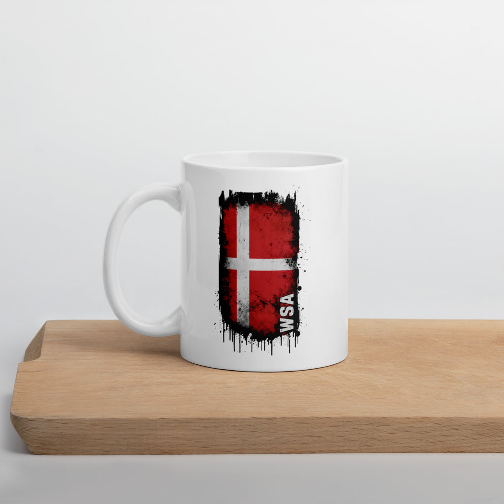 White mug with a flag design and 'WSA' text on a wooden surface