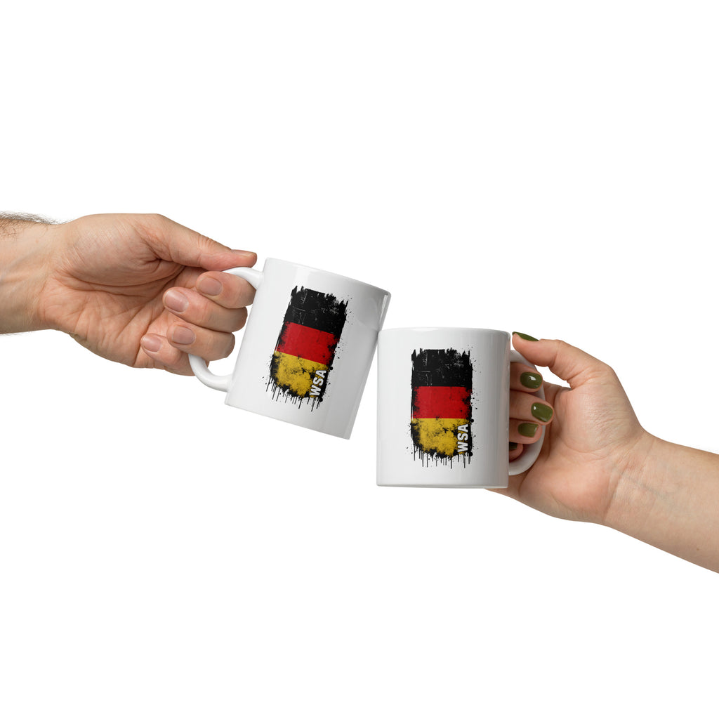 Two hands holding white mugs with a black, red, and yellow design on a white background