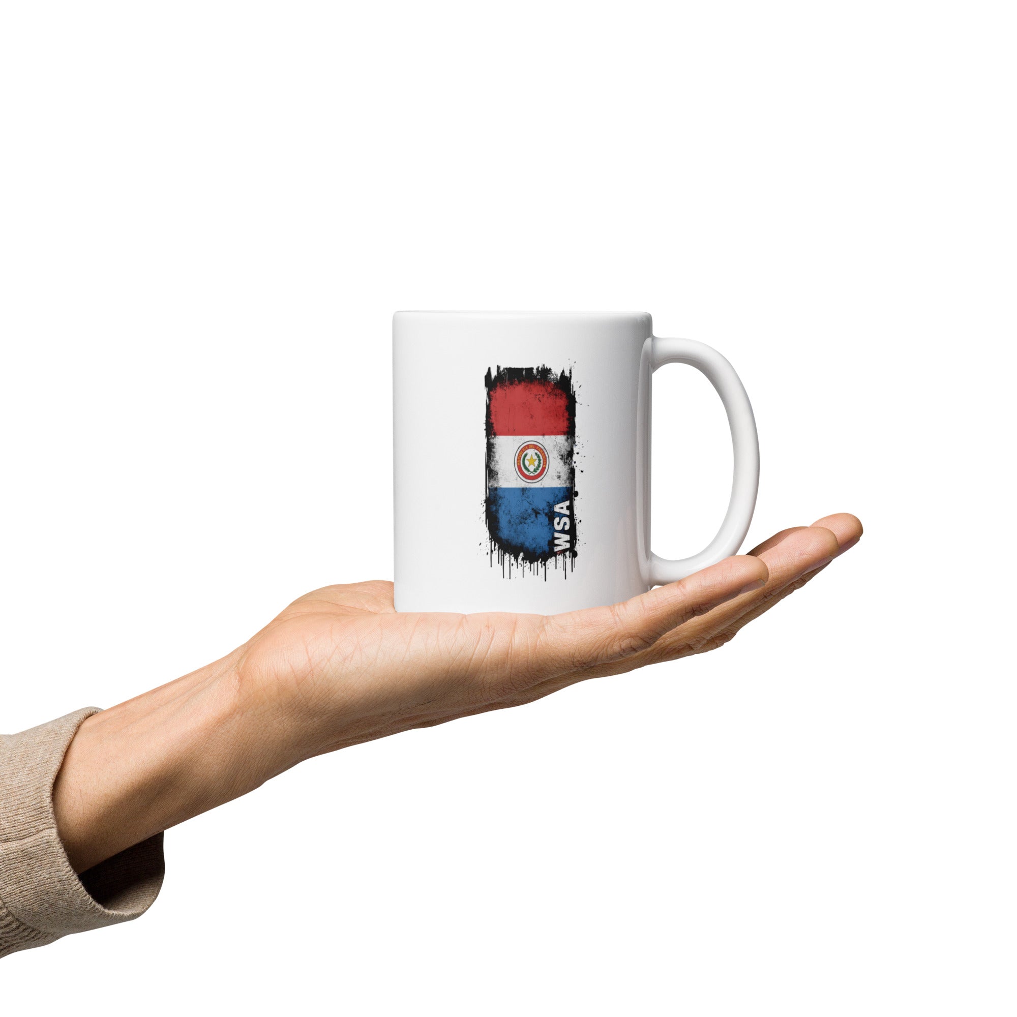 White mug with a colorful design held in a hand on a white background