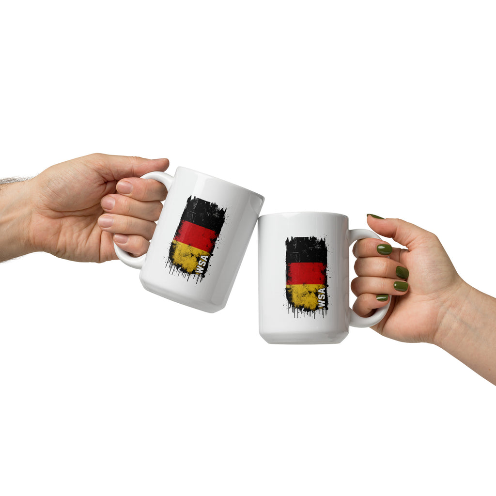 Two hands holding white mugs with a black, red, and yellow flag design on a white background