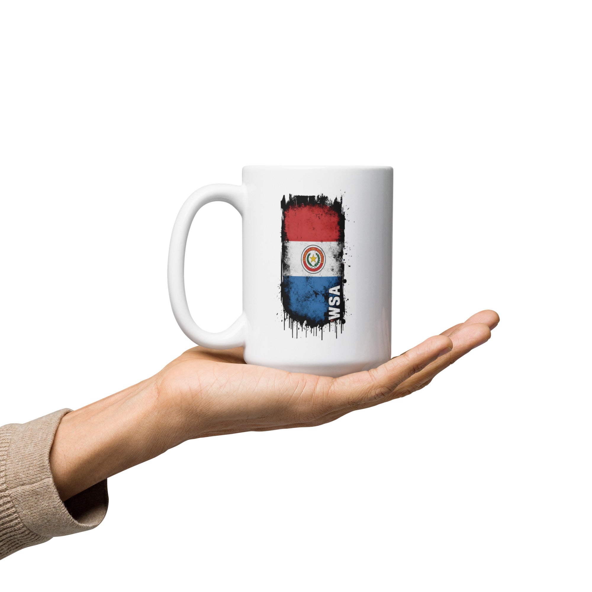 Hand holding a white mug with a colorful design on a white background