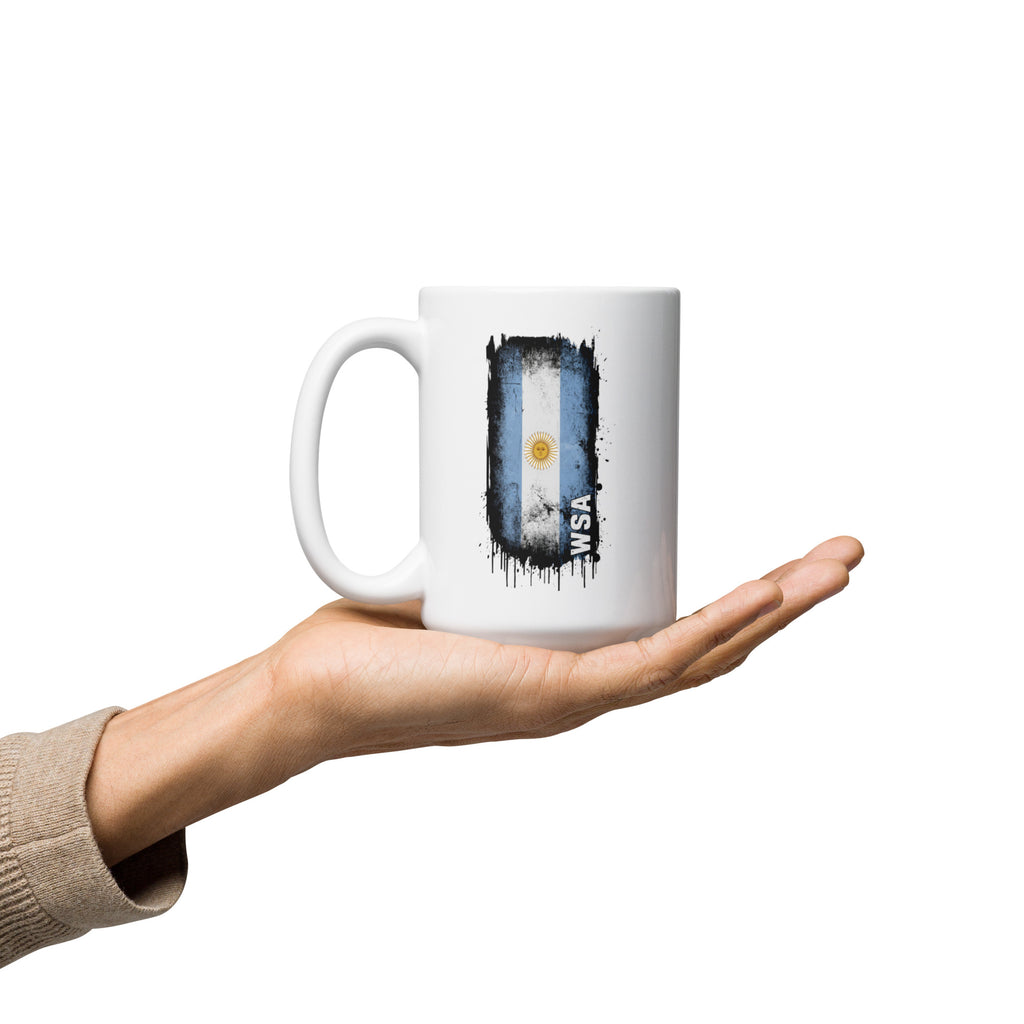 Mug with Argentina flag design held in a hand on a white background