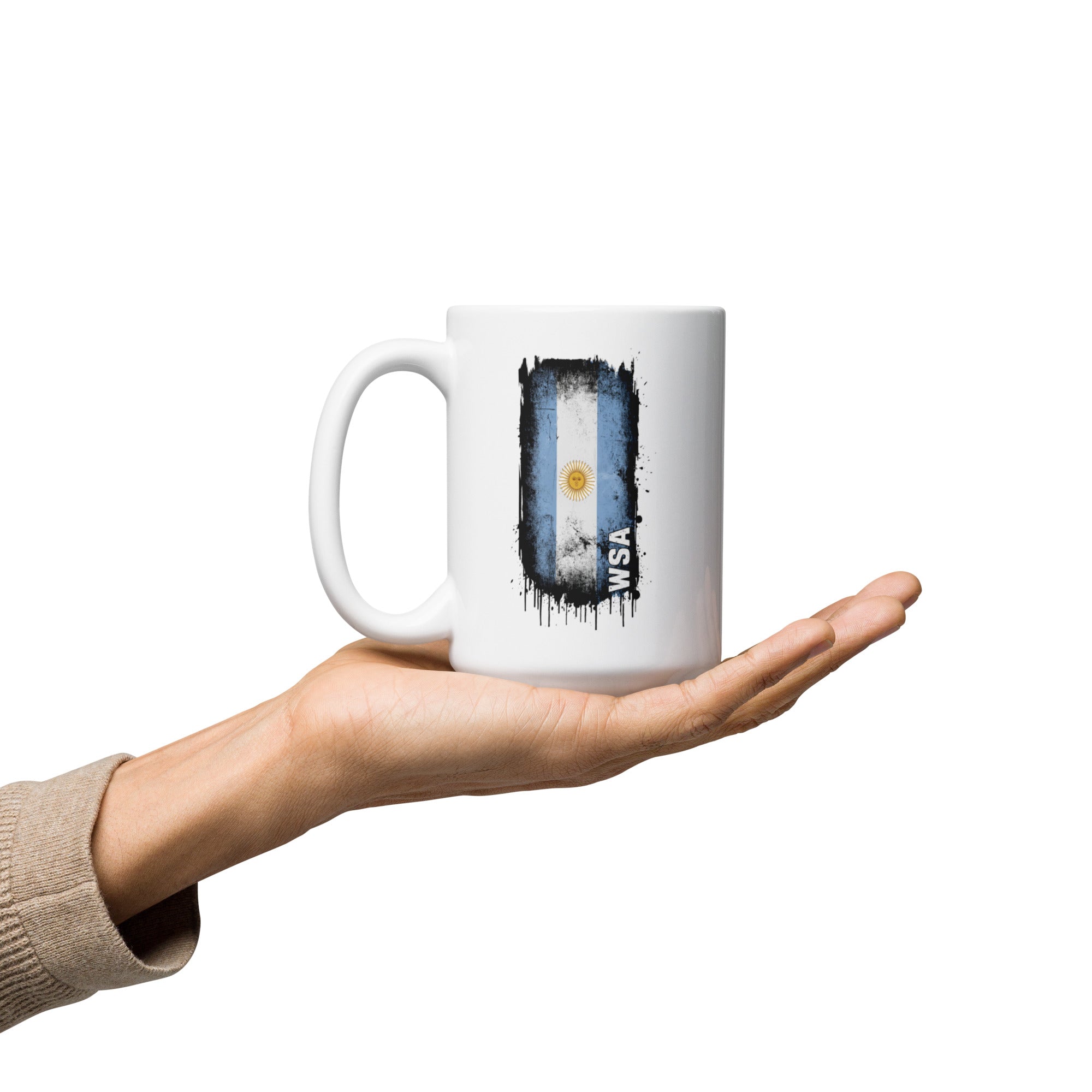 Mug with Argentina flag design held in a hand on a white background