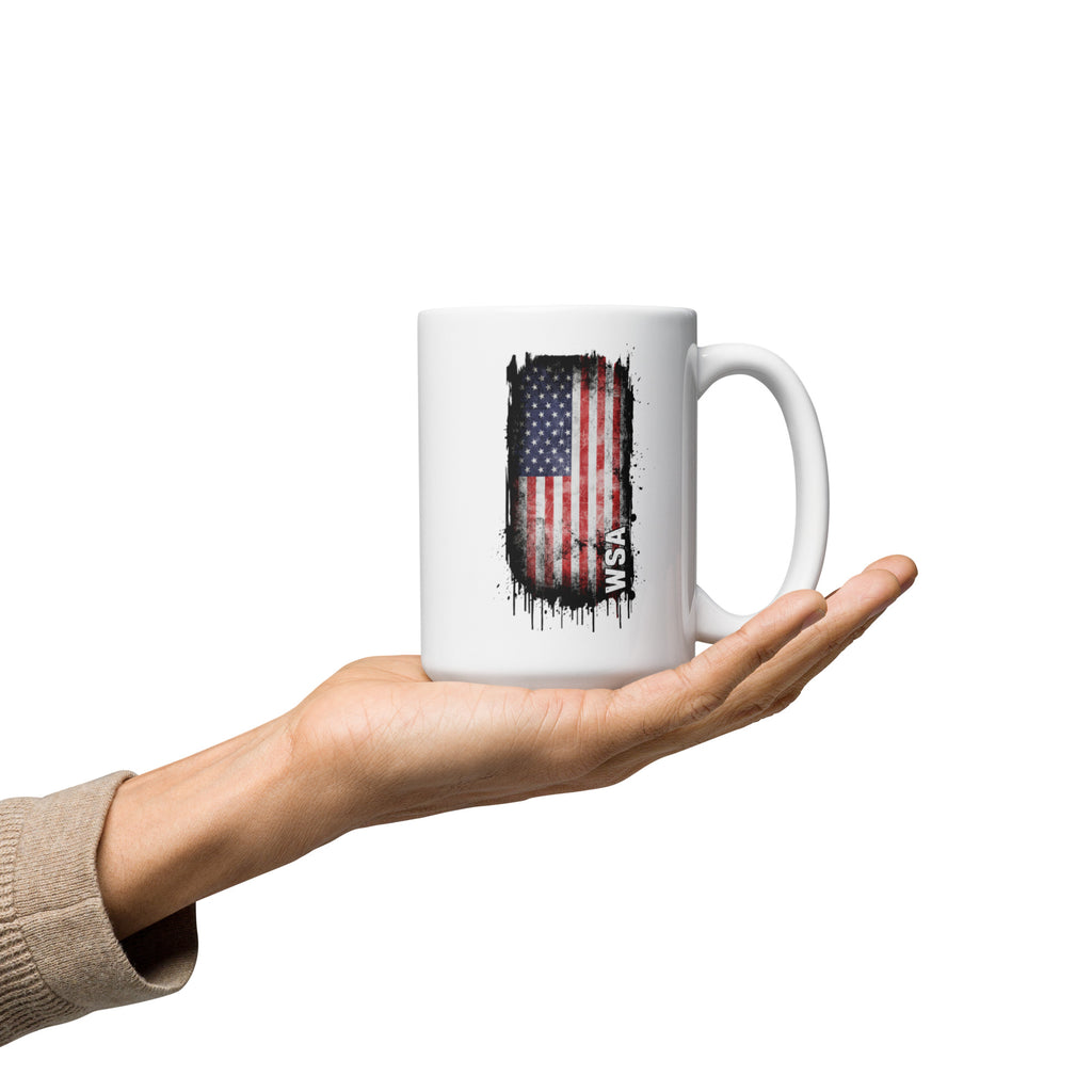 Hand holding a white mug with an American flag design on a white background