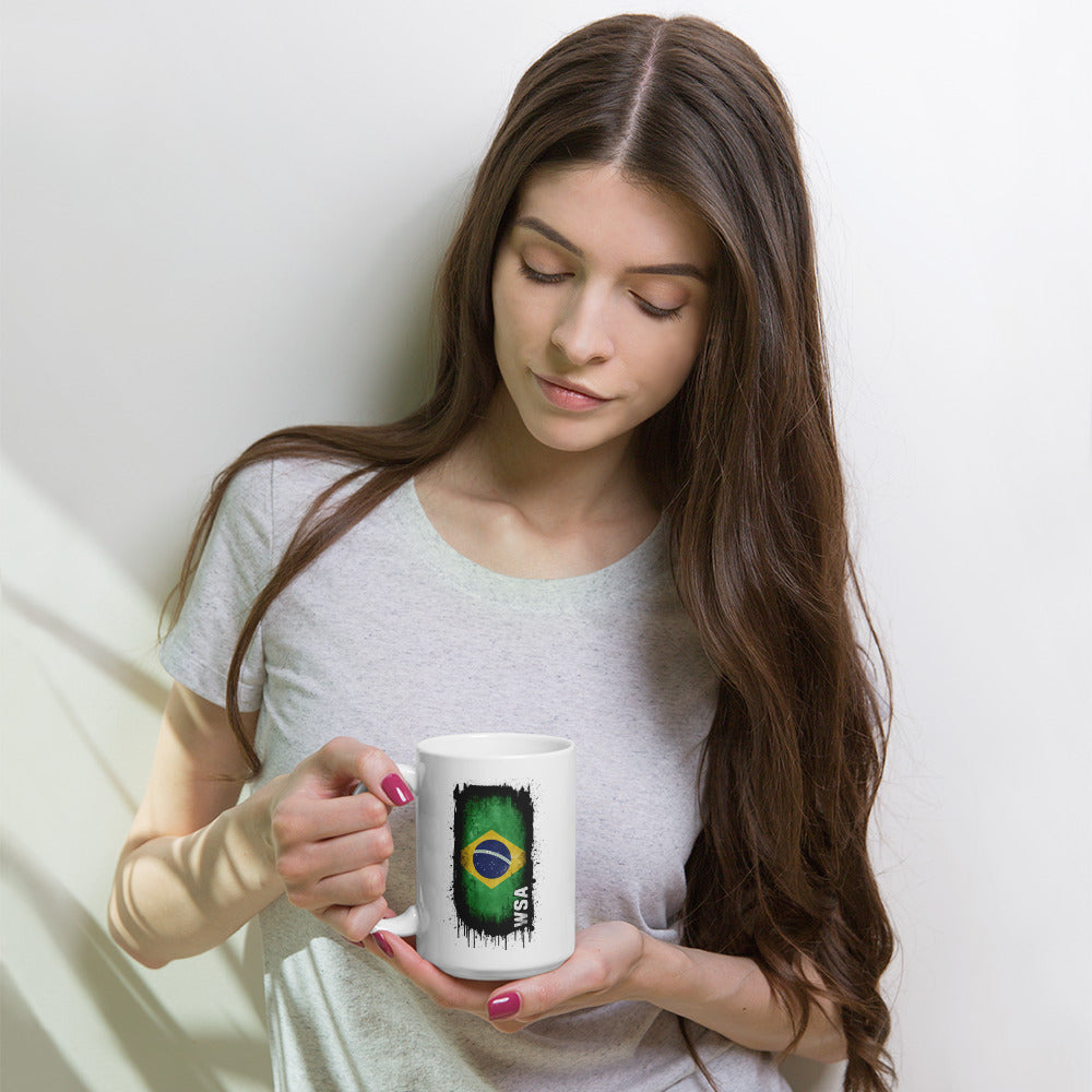 Woman holding a mug with a Brazilian flag design against a white background