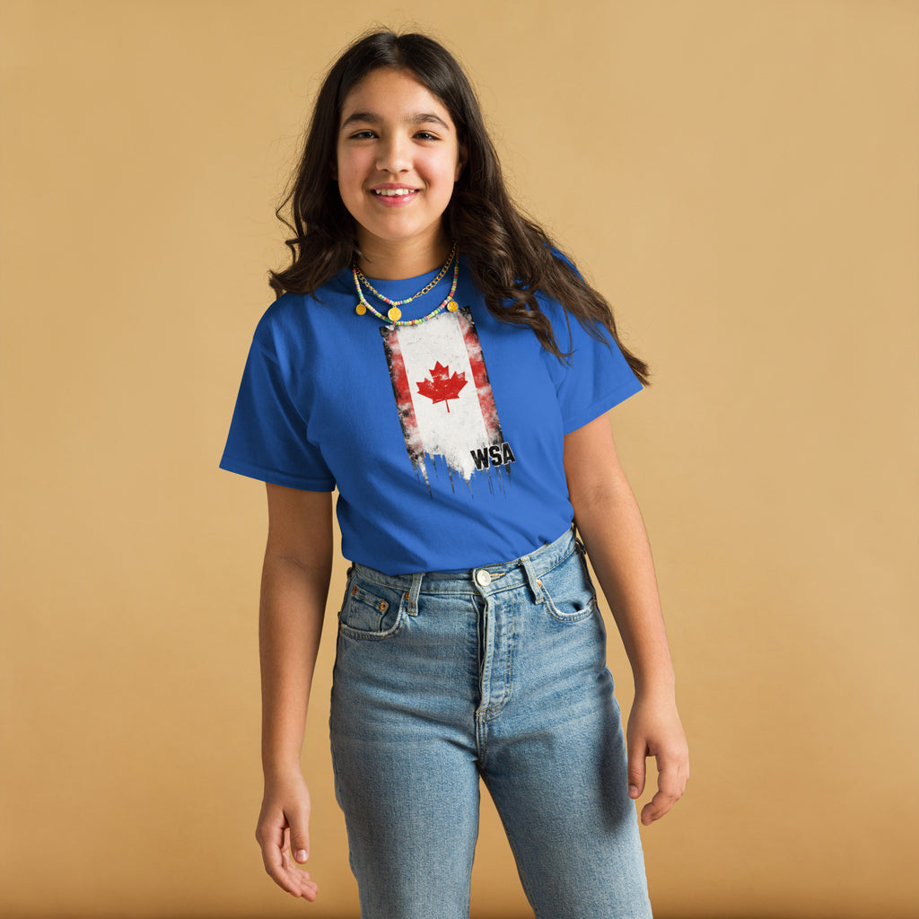 Person wearing a blue t-shirt with a graphic design on a beige background