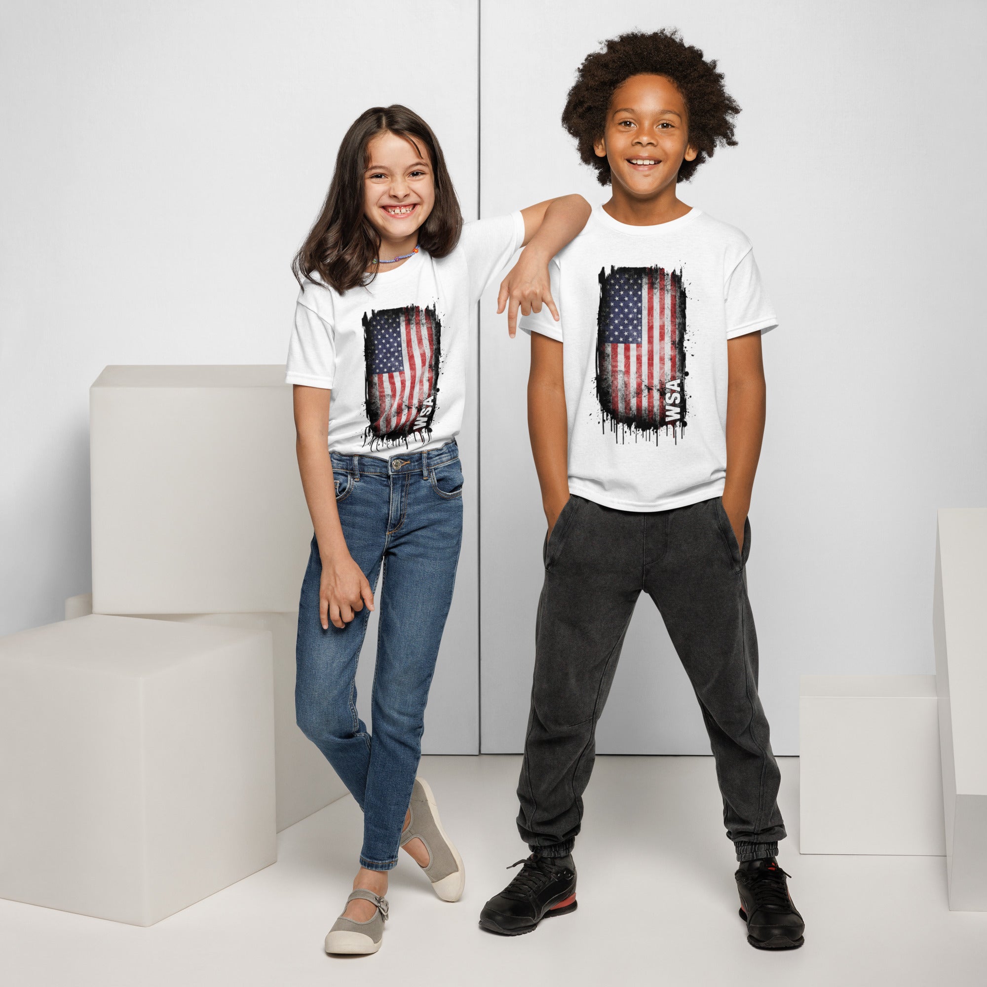 Two children wearing white t-shirts with American flag designs on a white background